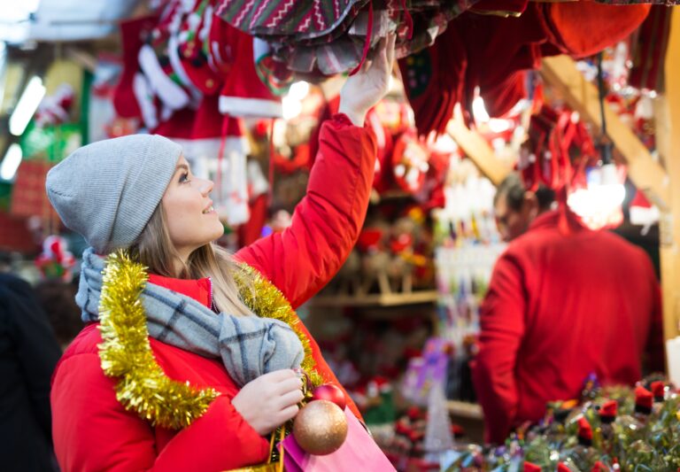 Young,Positive,Girl,Shopping,Decorations,On,Traditional,Christmas,Market,In