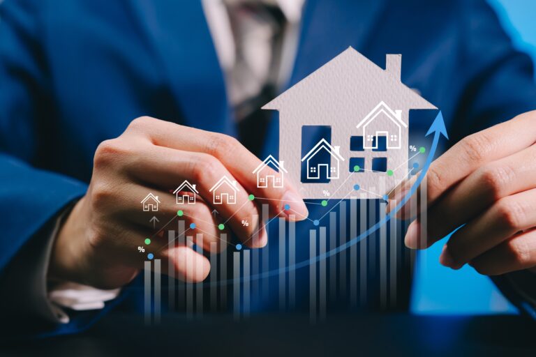 Businessman,Holding,House,Model,With,Rising,Graph,,Real,Estate,Investment